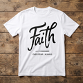 White t-shirt with 'Faith Over Fear Always' text on a wooden surface