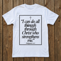 White t-shirt with black text and cross on a wooden background