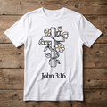 White t-shirt with a cross and flowers design and 'John 3:16' text on a wooden background