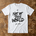 White t-shirt with 'Not of This World' text on a wooden surface