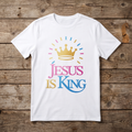 White t-shirt with 'Jesus is King' design on a wooden surface