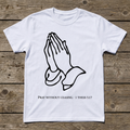White t-shirt with praying hands design and Bible verse on a wooden surface