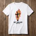 White t-shirt with a cross and flame design on a wooden background
