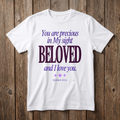 White t-shirt with purple text on a wooden background